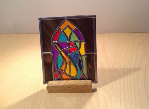 Arched window stained glass tea-light on oak plinth